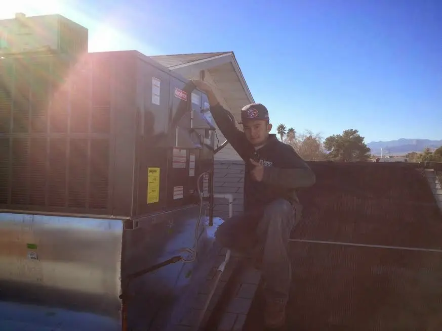 HVAC technician performing Heat Pump Repair on a rooftop unit in Corte Madera